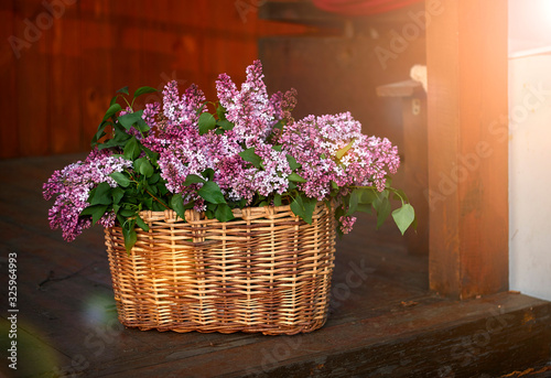 spring bouquet of tulips and lilac in a wicker basket © Александр Гаврилычев