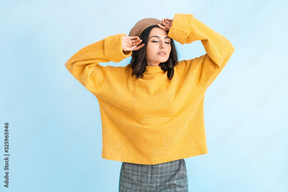 Beautiful young woman in warm sweater on color background Beautiful young woman in warm sweater on color background