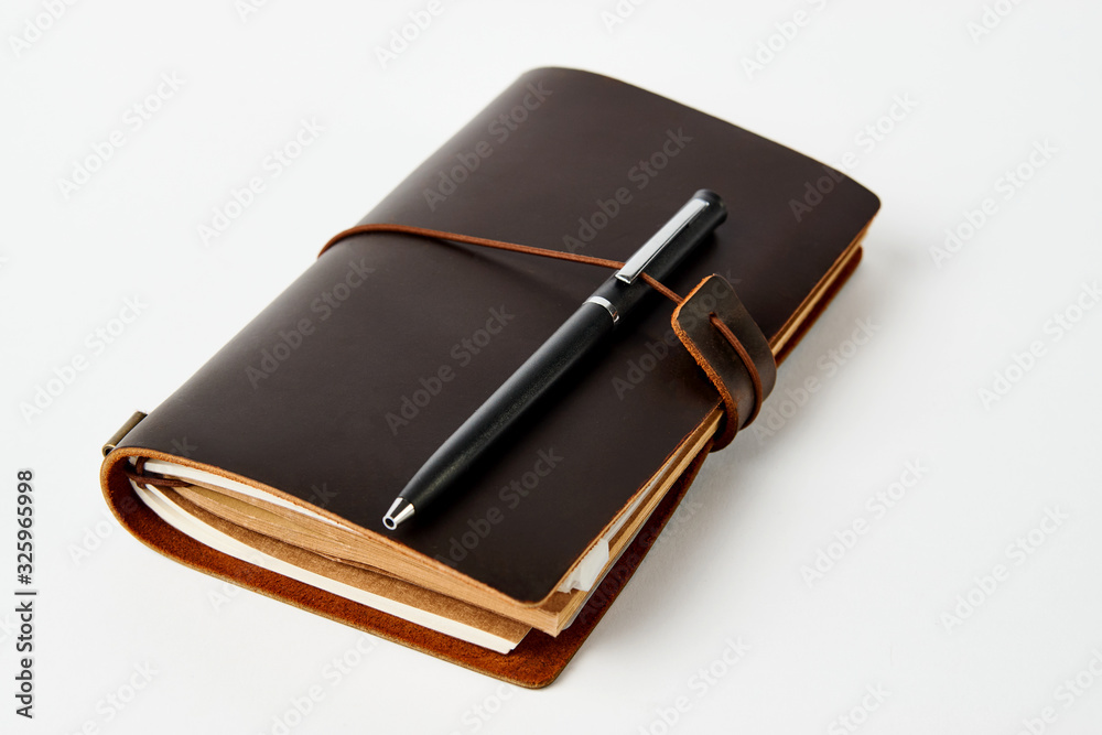 Business contact book and pen, close-up Business contact book and pen, close-up
