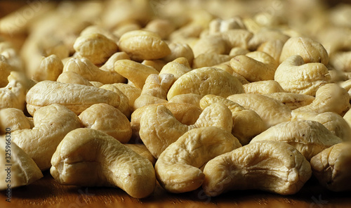 Raw cashew nuts on a textured wooden background, countertops, close-up