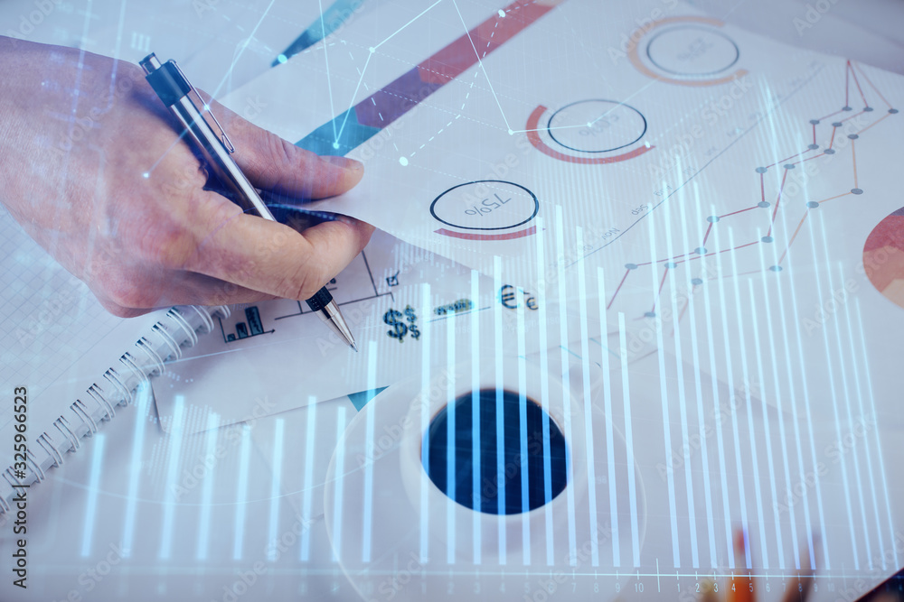Multi exposure of man planing investment with stock market forex chart.