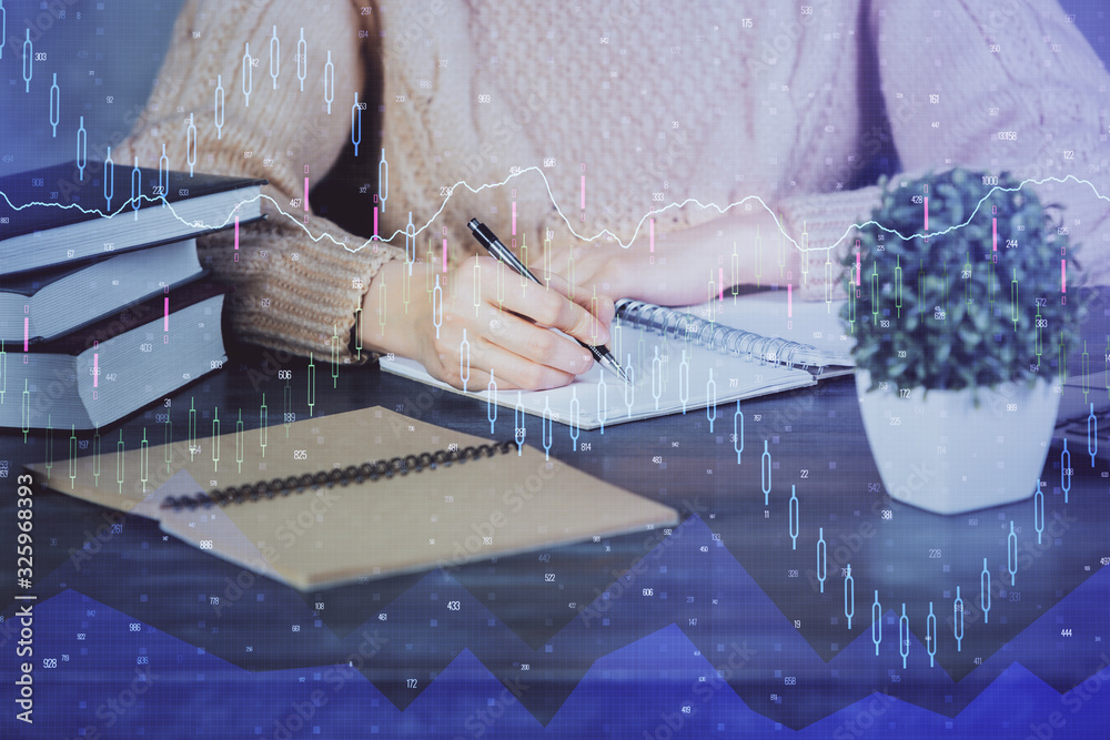 Forex graph on hand taking notes background. Concept of research. Double exposure Forex graph on hand taking notes background. Concept of research. Double exposure