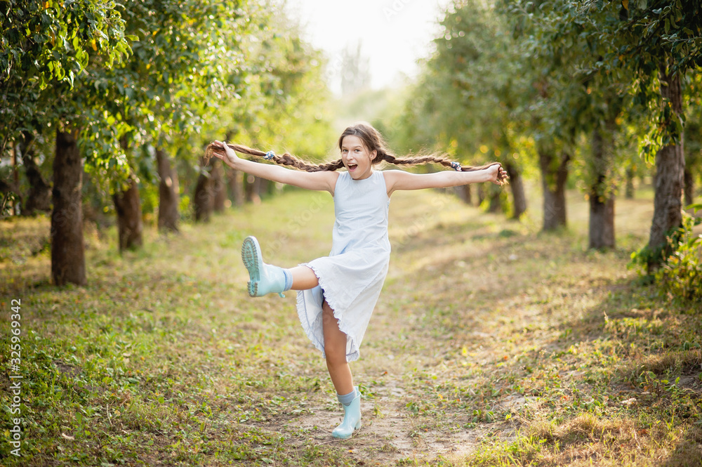 girl in orchard. garden with flowering trees. Allergy season. Dancing jumps girl in orchard. garden with flowering trees. Allergy season. Dancing jumps