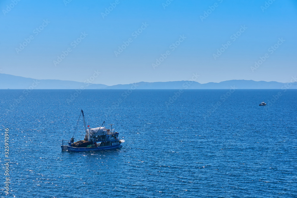 Fishing boat on the water catching fish Fishing boat on the water catching fish