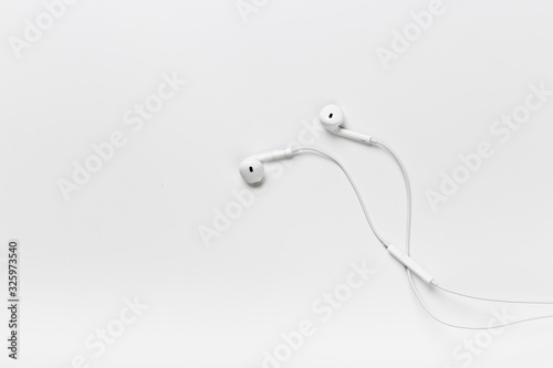 White modern headphones with a headset on a light gray background