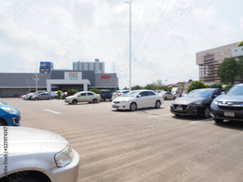 Blur image of Parking lot, Abstract blurred Parking lot, Blurred image exterior view of empty parking lots in modern shopping center.