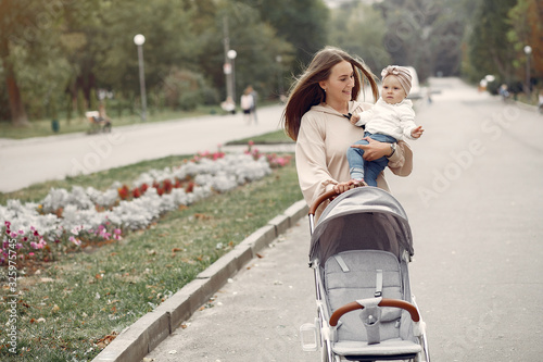 Mother with son. Woman use the carriages. Family in a autumn city © hetmanstock2