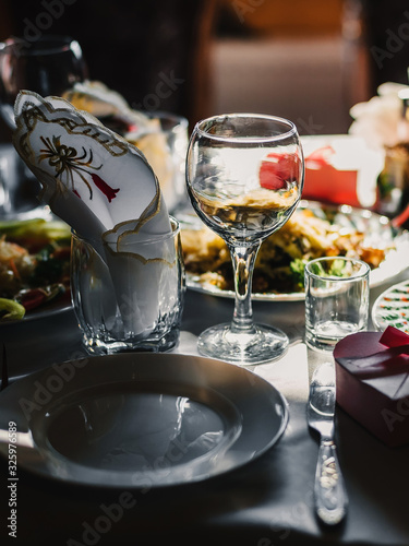 festive table in the restaurant with plates  glasses and Cutlery on a white tablecloth