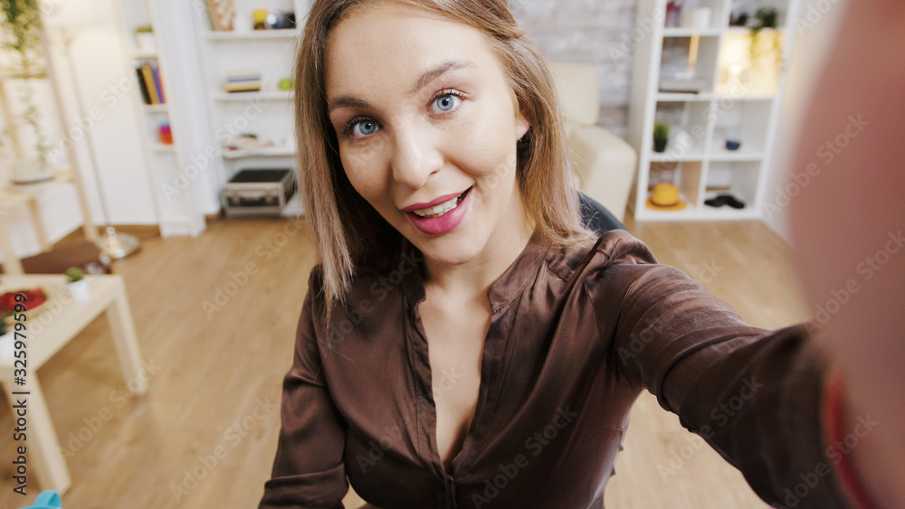POV video of beauty influencer smiling while recording a new fashion vlog