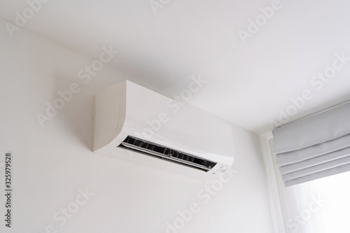 Air conditioner on white concrete wall in room space. © Lifestyle Graphic