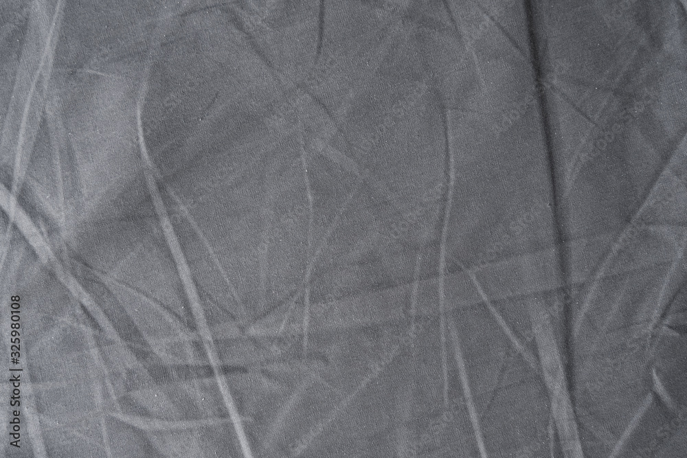 Abstract pattern of a gray crumpled bed sheet in bedroom. Gray wrinkled fabric texture rippled surface, Close up bed sheet in the bedroom. Abstract pattern of a gray crumpled bed sheet in bedroom. Gray wrinkled fabric texture rippled surface, Close up bed sheet in the bedroom.