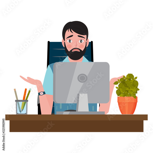 Confused man sitting on an office chair at a computer desk and looking at the monitor