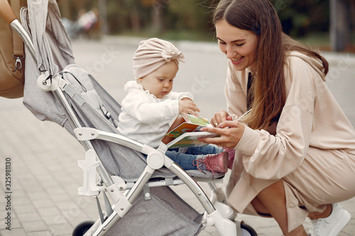 Mother with son. Woman use the carriages. Family in a autumn city photo