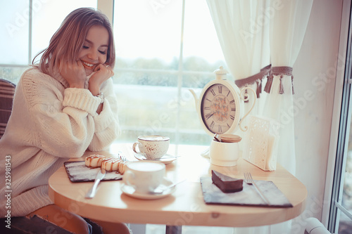 Photography morning breakfast in a bright cafe, a cozy portrait of a young model, lifestyle