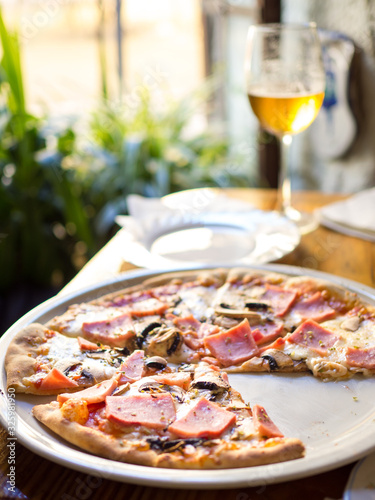 Restaurant table with pizza plate and beer glass