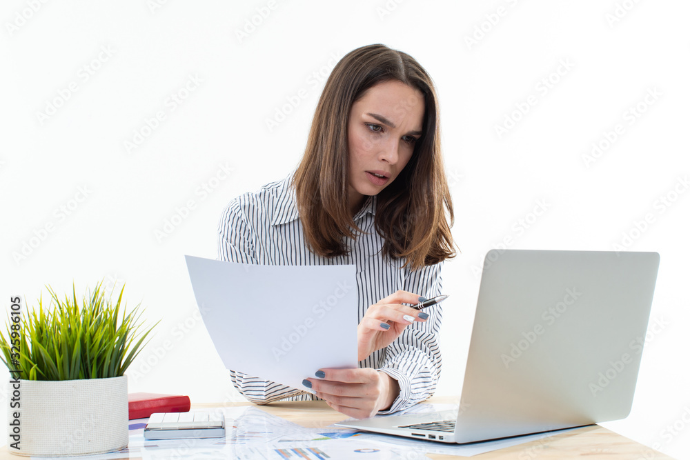 Working process in the office. The girl works at the computer Working process in the office. The girl works at the computer