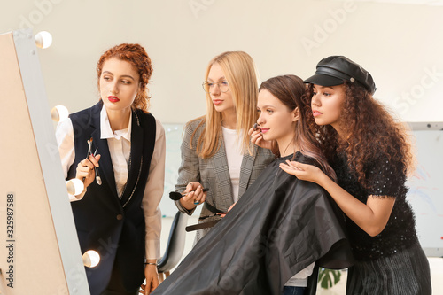 Young woman teaching studen...