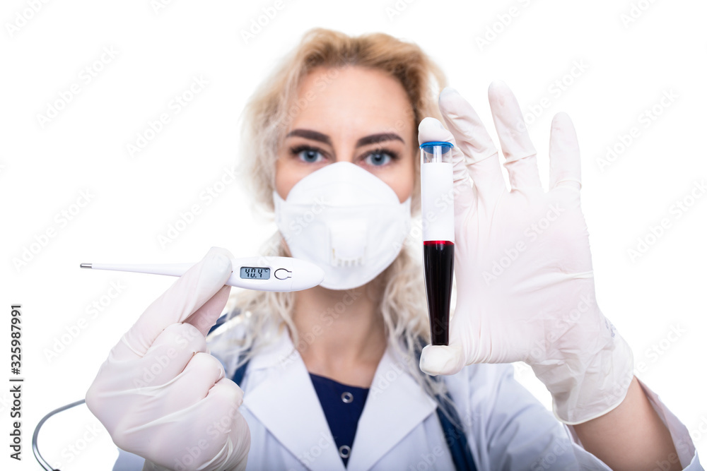 The girl the doctor holds a test tube with blood and an electronic thermometer. Disease prevention The girl the doctor holds a test tube with blood and an electronic thermometer. Disease prevention