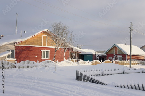 wooden village houses in the North in winter © Natali Arkhangelsk