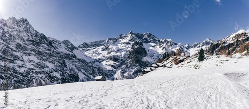 Panoramic view in the snowy mountains of Valsesia taken from the Otro valley, during a sunny day near the town of Alagna, Italy - February 2020.