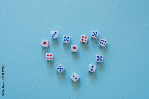  White game cubes on a blue background. Heart. Chance to win  lucky. Love. View from above. Close-up. The concept of gambling. Stack of dice. Concept for games  playing field  role-playing game  risk 