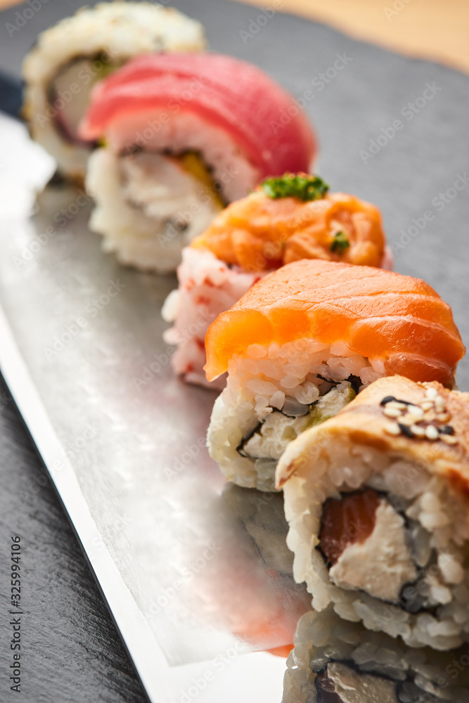Various kinds of sushi roll set served on a knife blade. Japanese food Various kinds of sushi roll set served on a knife blade. Japanese food