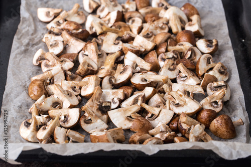 A portion of fresh chopped mushrooms on a baking sheet before baking.
