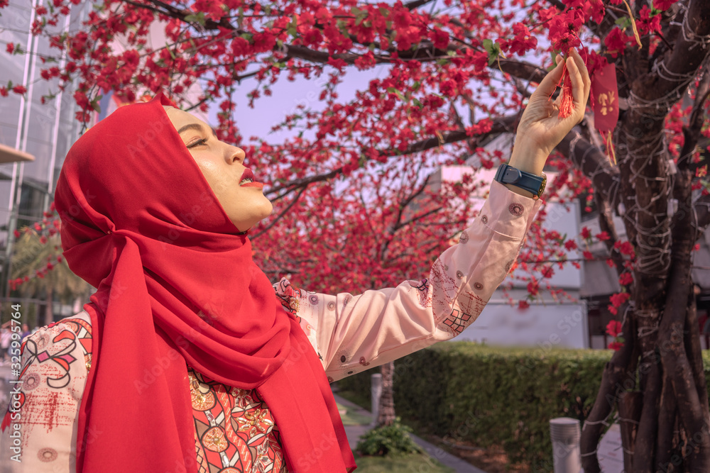Islamic women admire the beauty of the cherry blossoms created to decorate during the festival.