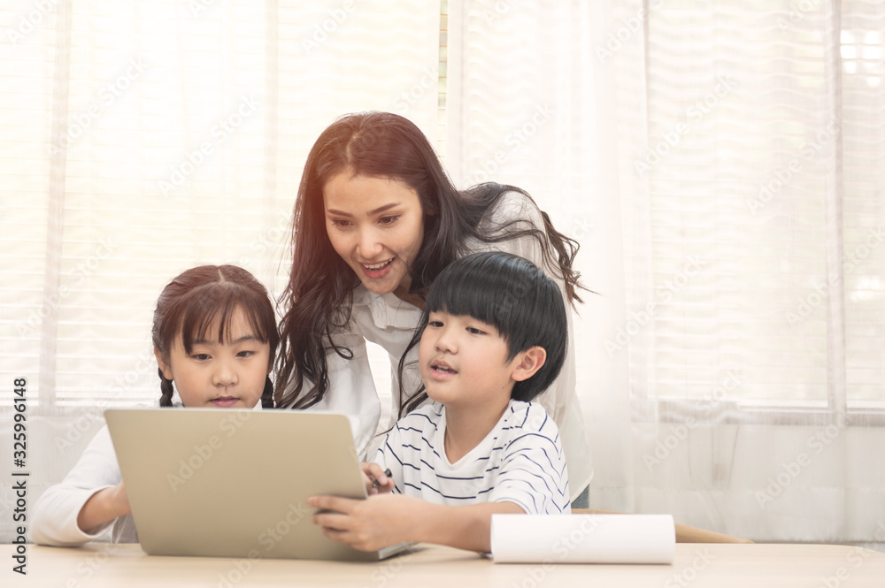 Asian family with children use laptop at home Asian family with children use laptop at home