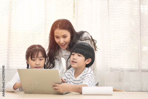 Asian family with children use laptop at home