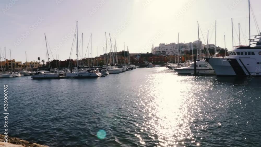 sunset with middle light reflecting on the sea close to the port