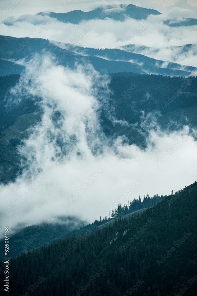Scenic landscape with blue mountains in the clouds Scenic landscape with blue mountains in the clouds