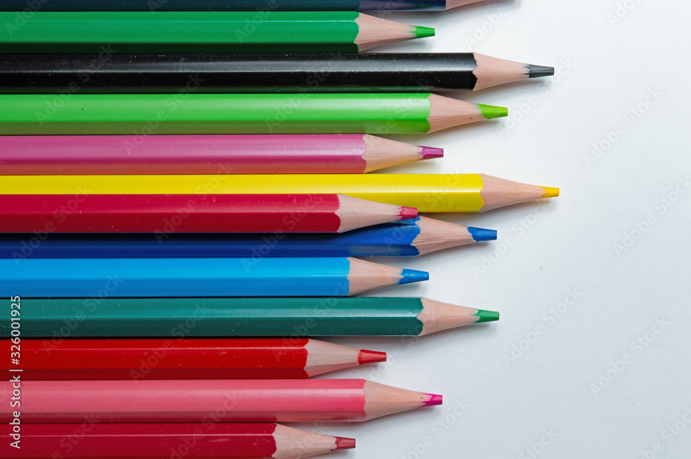 multicolored pencils on a white background. top view.