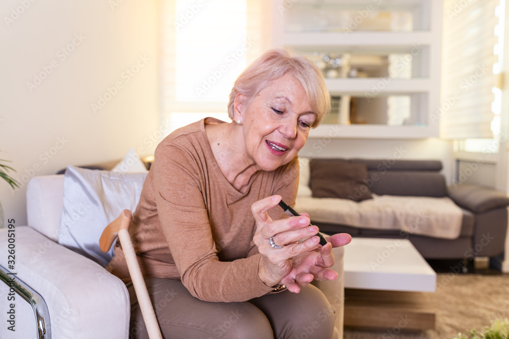 Blood sugar testing at home. Checking Blood Sugar Level At Home. Diabetic Checking Blood Sugar Levels. Woman checking blood sugar level by glucometer and test stripe at home Blood sugar testing at home. Checking Blood Sugar Level At Home. Diabetic Checking Blood Sugar Levels. Woman checking blood sugar level by glucometer and test stripe at home