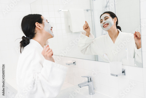 Optimistic young woman take care of skin