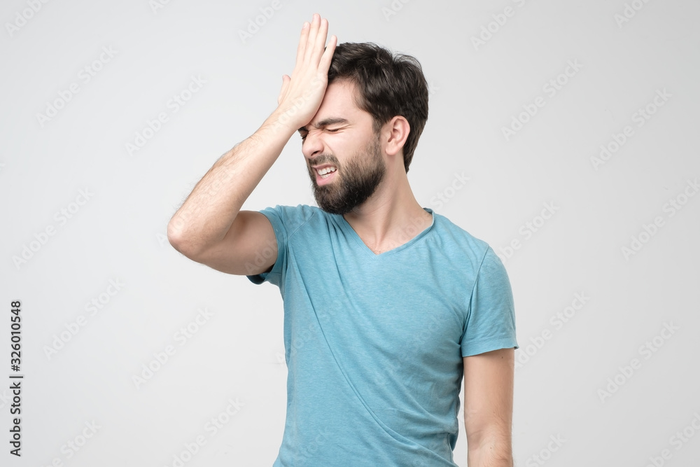 Hispanic young man slaps himself on head forgetting to buy food. Hispanic young man slaps himself on head forgetting to buy food.