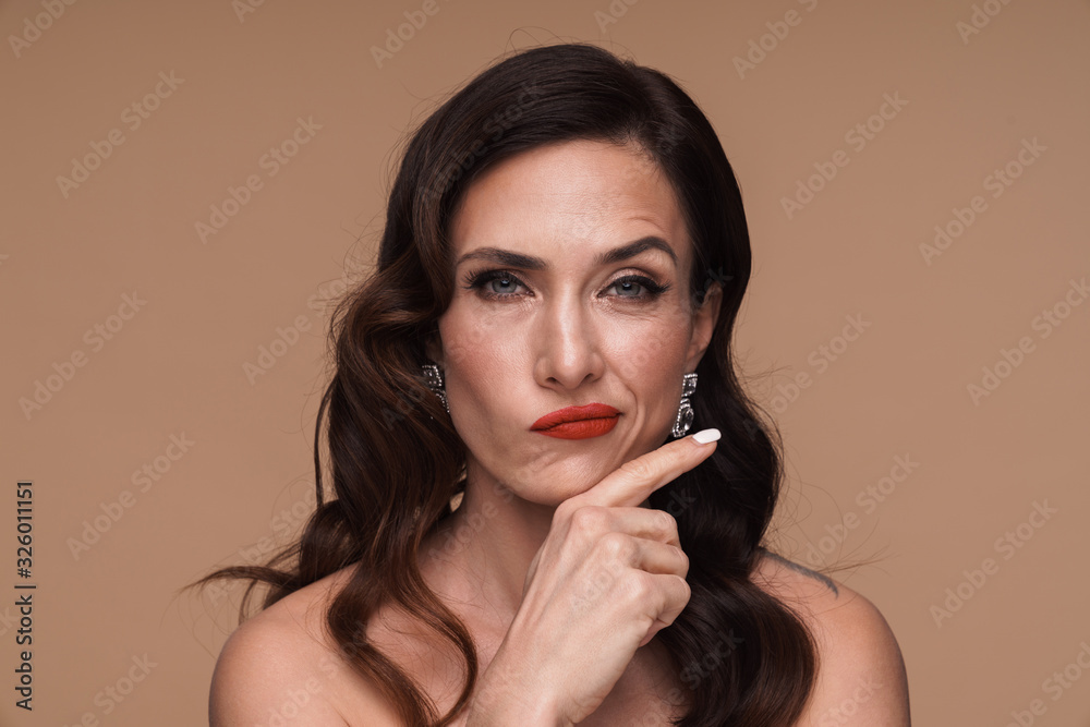 Beauty portrait of brunette adult half-naked woman frowning and thinking Beauty portrait of brunette adult half-naked woman frowning and thinking