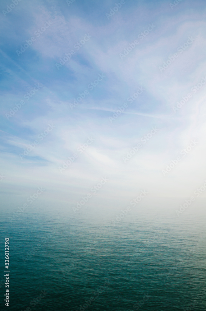 Scenic view of sky and sea blending into a misty white horizon
