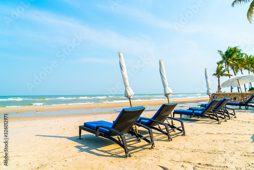 Fototapeta Naklejka Na Ścianę i Meble -  beach chair on beach with sea and blue sky background