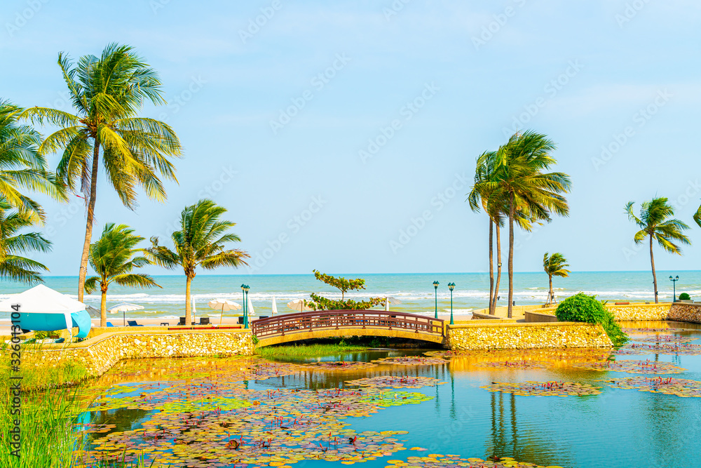 bridge with coconut palm tree and sea beach background