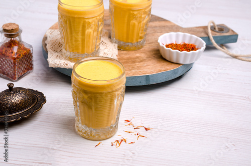 Yellow smoothie in glass photo