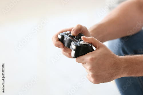 Man playing video games at home, closeup