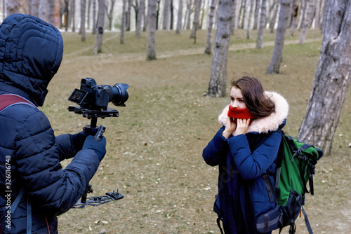 Photographer and woman in late wither forest