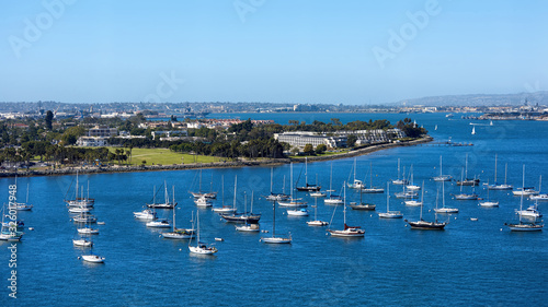 Sailing boats in waterfront area. Cityscape on background