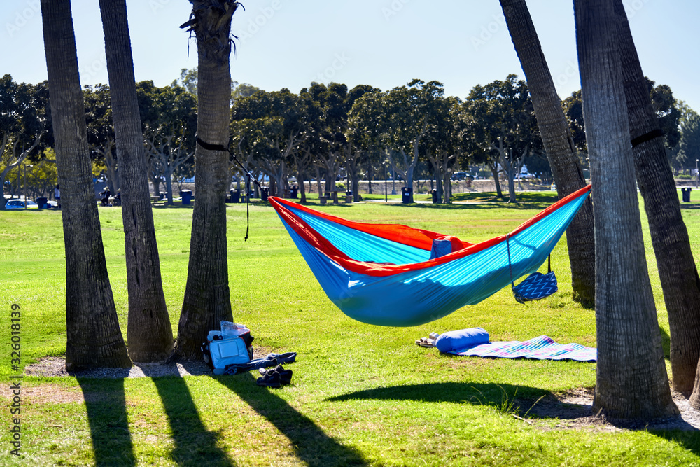 Hammock and sleeping pad in a local park. Person relaxing