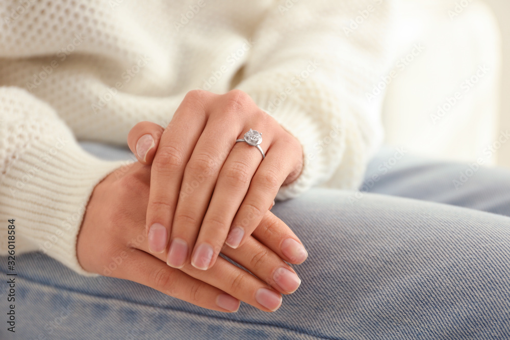 Young woman wearing beautiful engagement ring, closeup Young woman wearing beautiful engagement ring, closeup