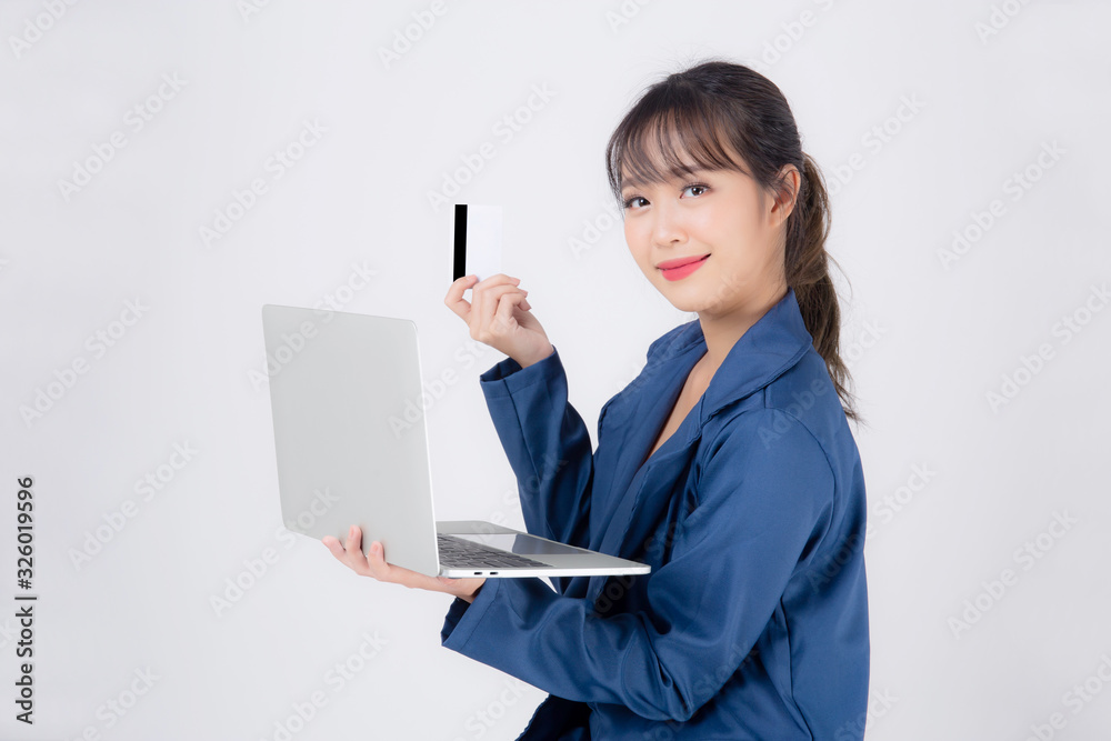 Beautiful young asian business woman happy holding credit card and laptop computer with payment shopping online isolated on white background, businesswoman confident with cash back after using credit. Beautiful young asian business woman happy holding credit card and laptop computer with payment shopping online isolated on white background, businesswoman confident with cash back after using credit.