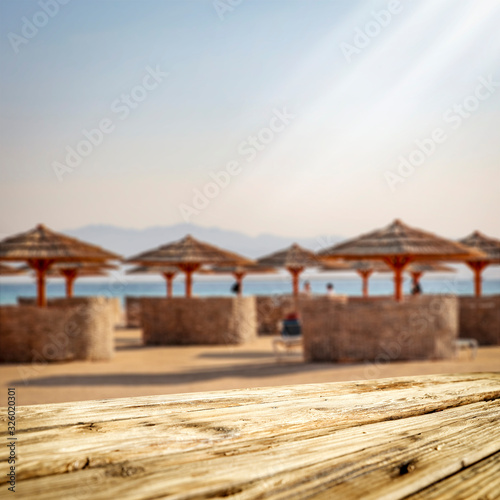 Wooden desk of free space and summer beach landscape. 