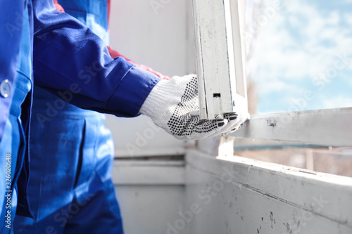 Photos Workers dismantling old window indoors, closeup view