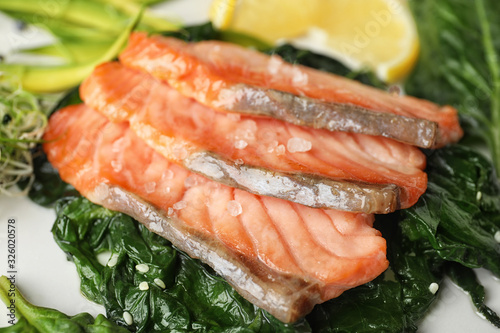Tasty freshly cooked salmon with spinach, closeup
